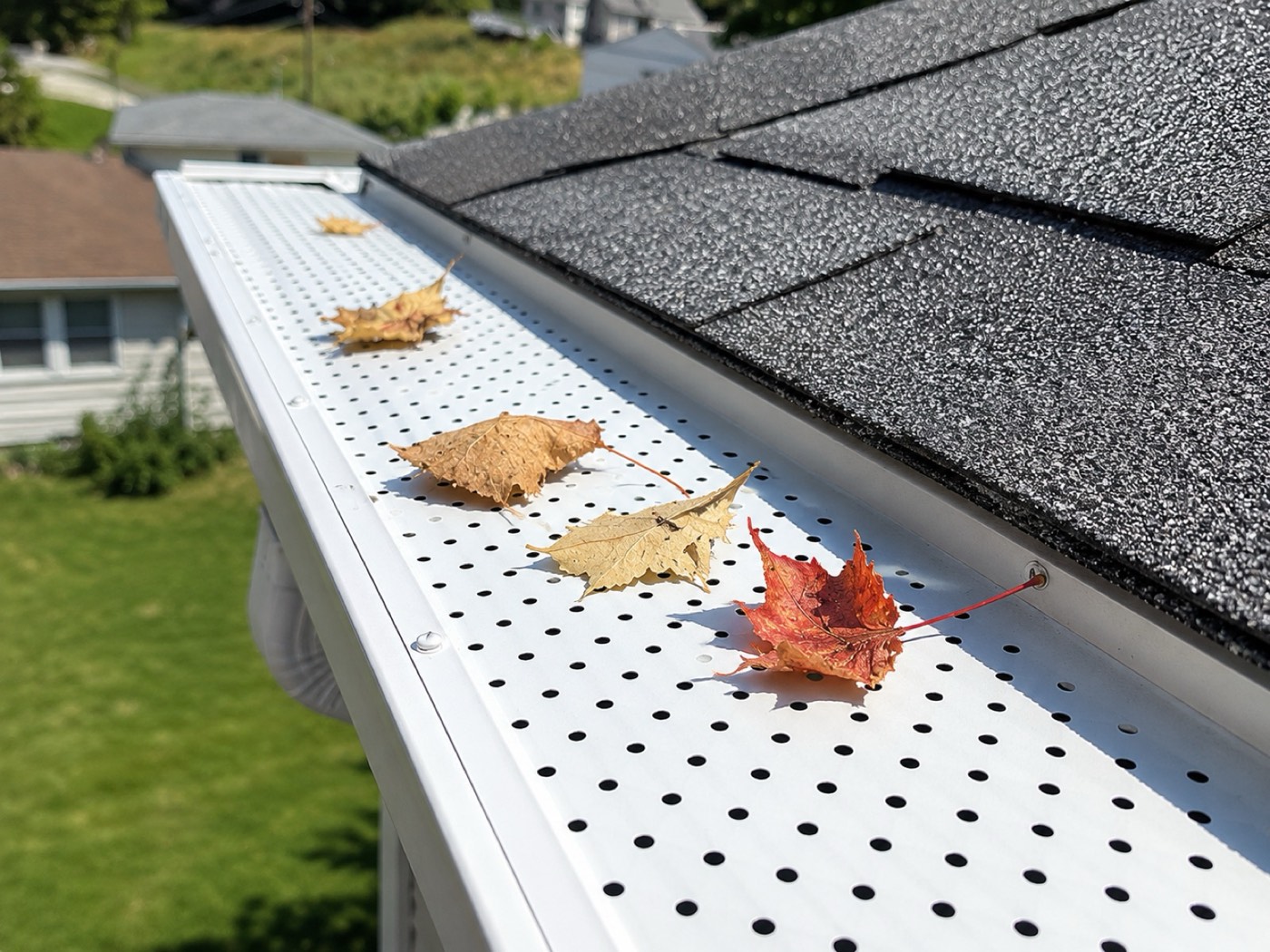 Close-up of gutter guards installed over a home's gutters keeping leaves out